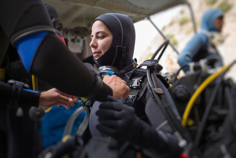 female diver preparing to dive