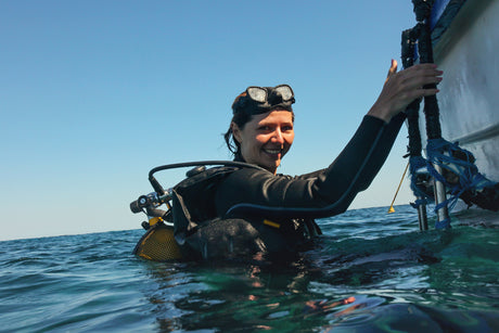 female scuba diver getting back onto boat