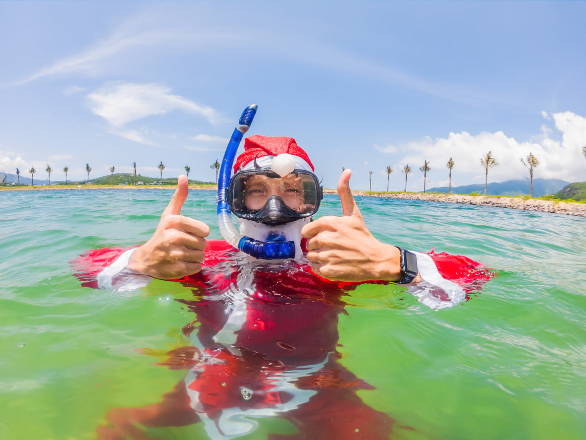 man dressed as santa snorkelling